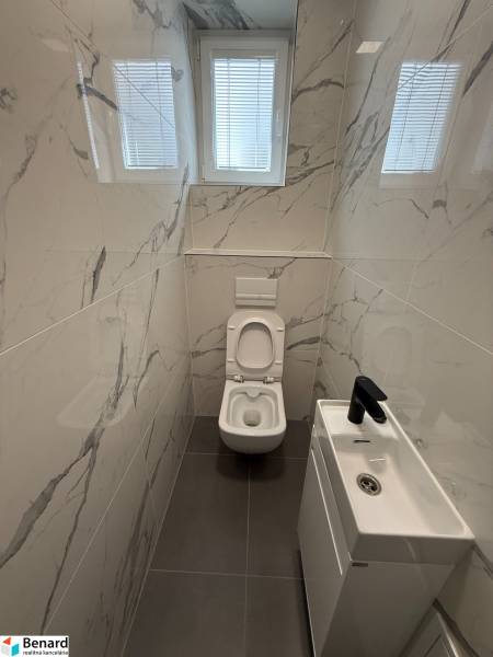 Bathroom with toilet and sink in a 3-room apartment.