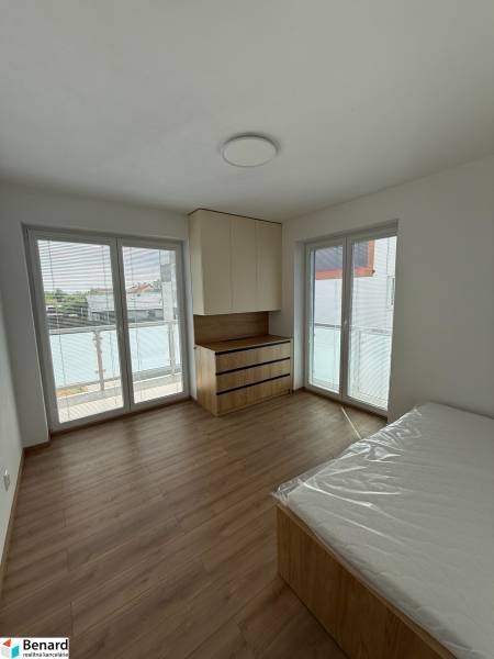 Bedroom with built-in wardrobes and a balcony in a 3-room apartment.