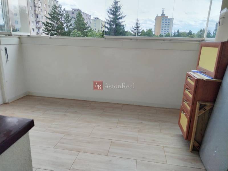 A glazed balcony with a view of the housing estate from a 2-room apartment.