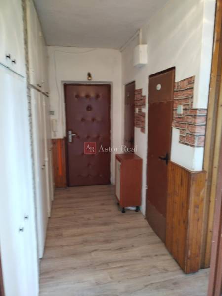 Entrance hallway in a 2-room apartment with closets and brown doors.