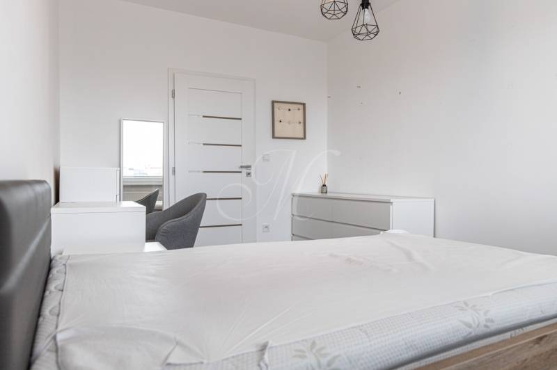 Bedroom with a bed, wardrobe, and armchair in a 3-room apartment.