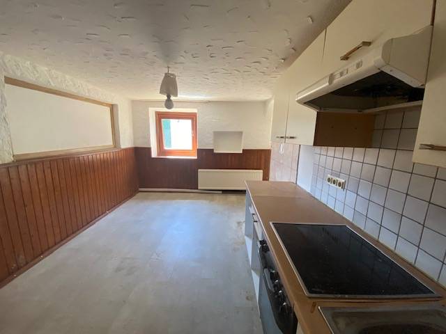 A kitchen with wooden paneling and tiles during renovation, Apartment construction.