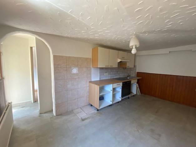 A kitchen space in the process of apartment construction with simple furnishings.
