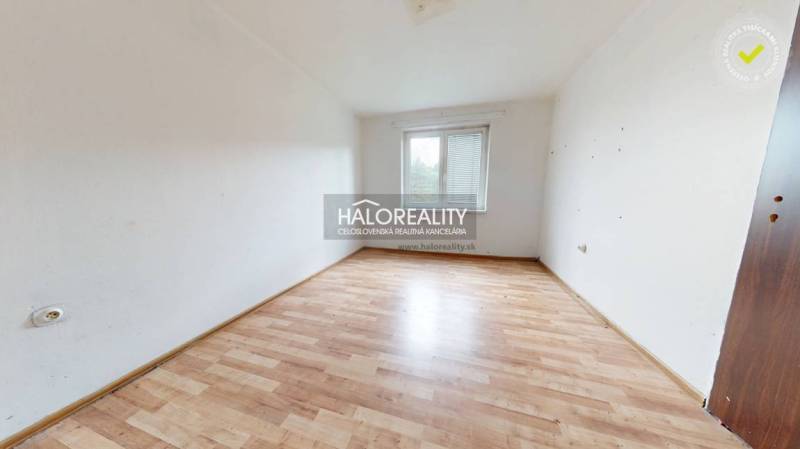 A spacious room with a wooden floor and a window in a 3-room apartment.