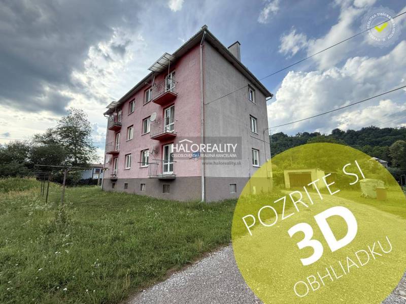 Exterior of an apartment building in Hnúšťa with a 3-room apartment and green surroundings.
