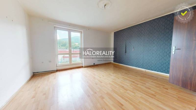 A spacious room with laminate flooring and a large window, part of a 3-room apartment.