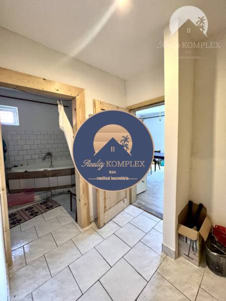 Interior of a family house with entrance to the bathroom and white tiles.