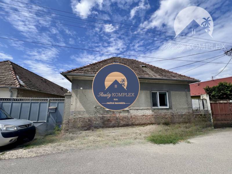 A family house in Horné Saliby with a traditional roof and simple facade.