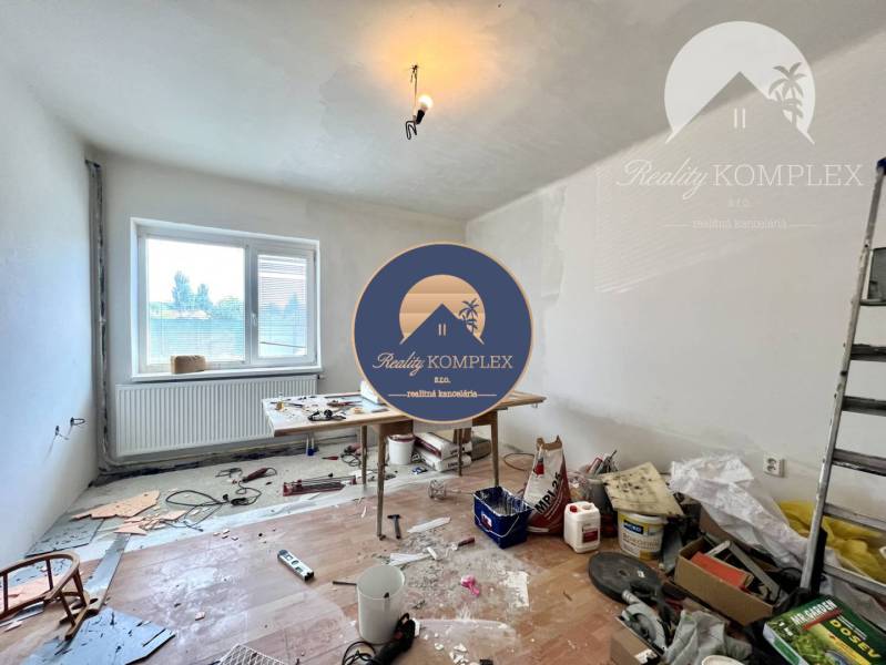 Renovation work in a family house, a table with building materials, a ladder, unfinished flooring.