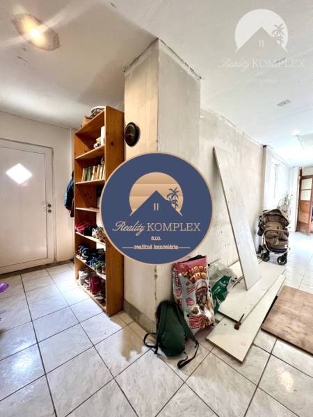 Hallway in a family house with a shelf for books and shoes.