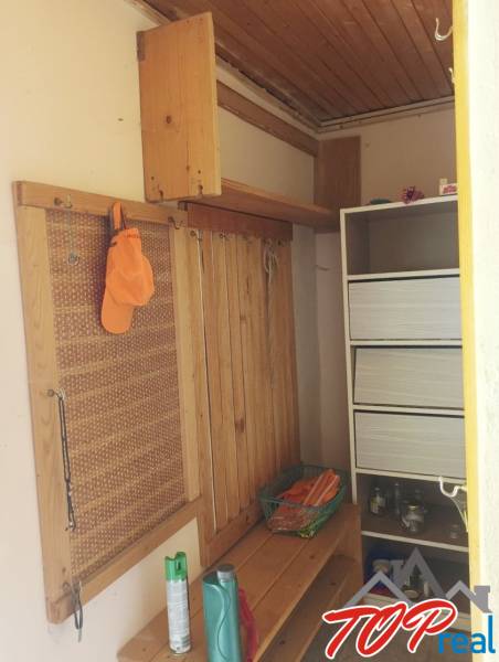 The interior of the cabin with wooden paneling and simple storage space.