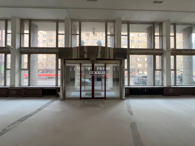 Spacious commercial spaces with large windows and glass doors.