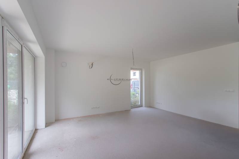 An empty room with large windows in a 2-room apartment ready to be furnished.