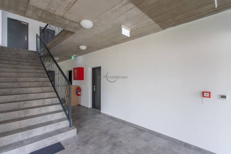 A view of the staircase with a metal railing in a 2-room apartment.