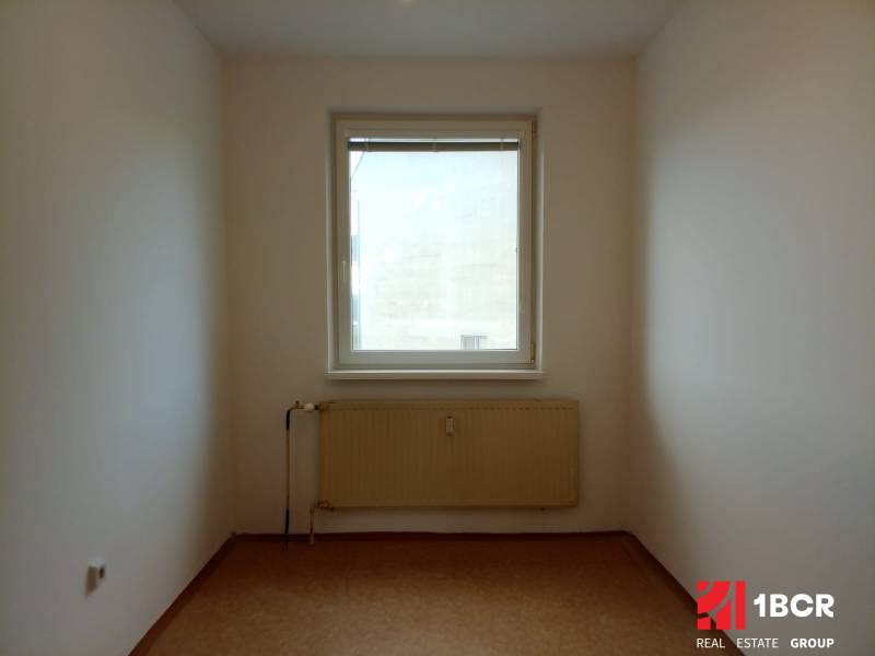 A small room with a radiator and a window in a 3-room apartment.