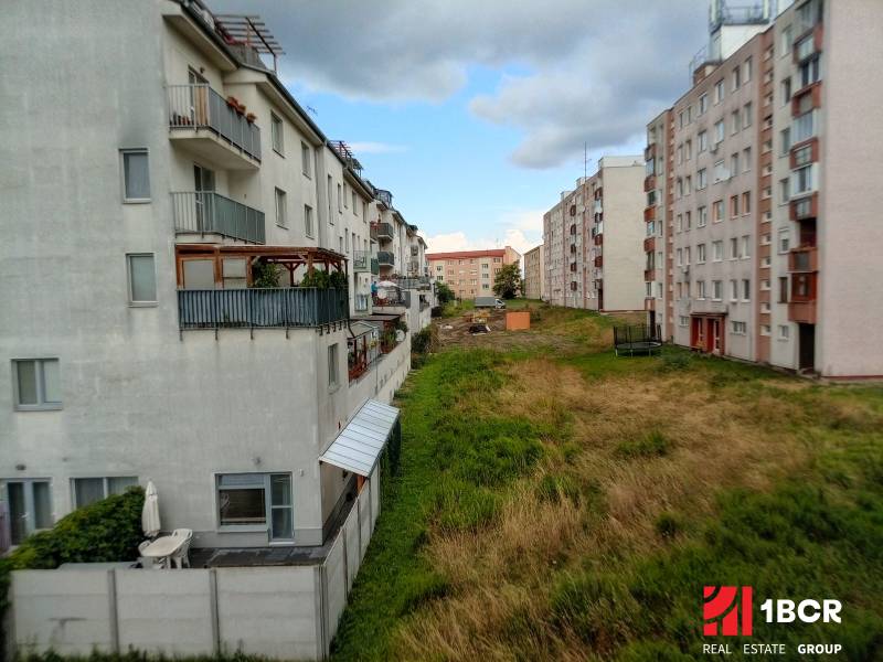 The exterior of apartment buildings on Jilemnického Street in Stupava, next to a green area.
