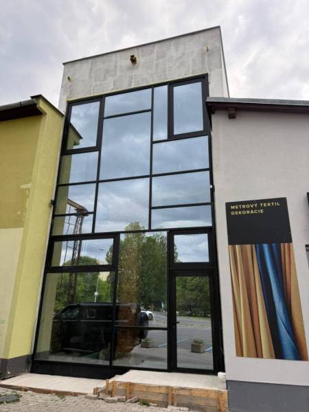 Glazed commercial spaces in Poprad with advertising for textile decorations.
