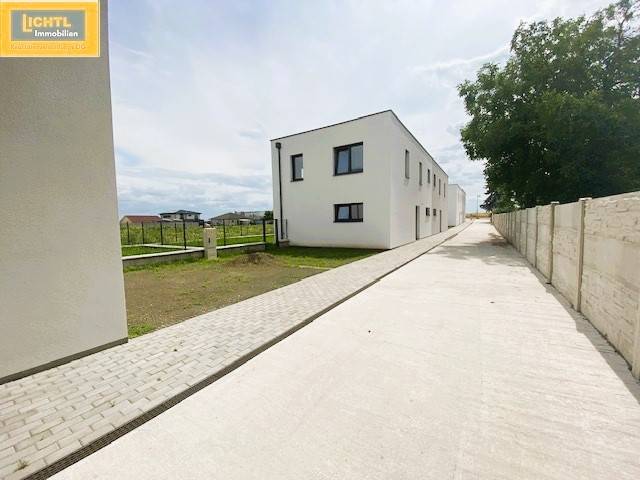 Modern buildings on Untere Hauptstraße in Potzneusiedl, the photograph captures the exterior with a driveway.