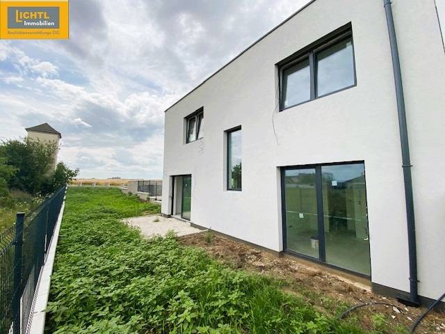 Exterior of a 5 or more room apartment in Bratislava with windows and greenery.