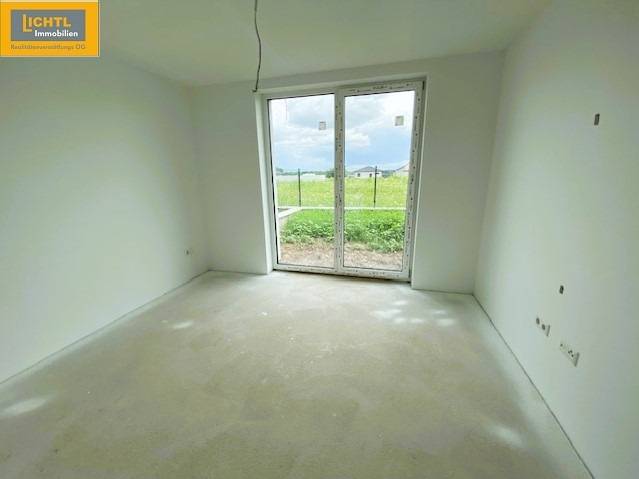 Spacious room with a large window and a view of the exterior, ideal for a 5 or more bedroom apartment.