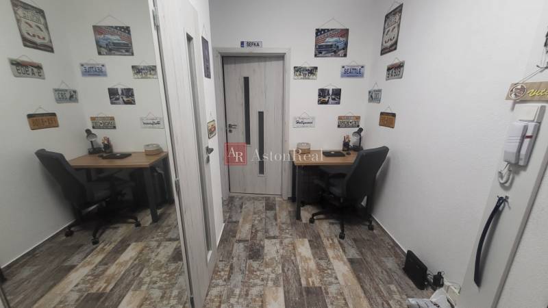 A small work corner in a studio apartment with decorations on the walls.