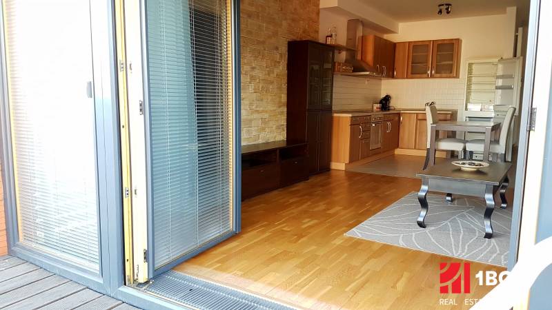 Living room with kitchen and dining table, 2-room apartment, wooden floor.
