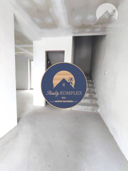 Interior of a family house with concrete stairs and plastered walls ready for finishing.