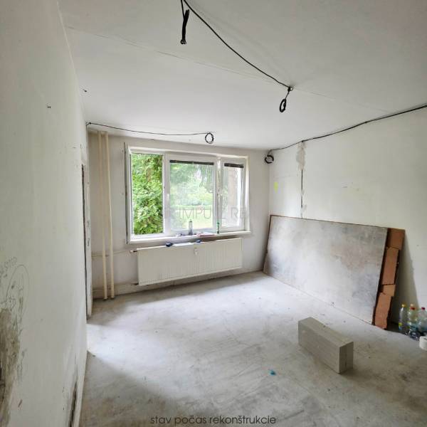 Room renovation with bare walls and a window, 2-room apartment.