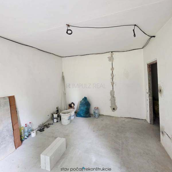 Under-construction interior of a 2-room apartment with visible electrical installations and building materials.
