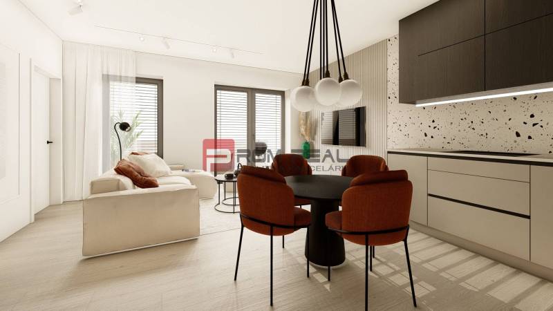Interior of a 3-room apartment with a comfortable sofa, dining table, and kitchen unit.
