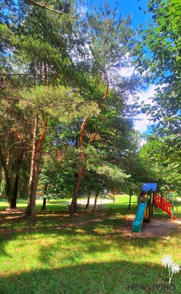 A playground in the middle of trees in the Juh housing estate in Trenčín.