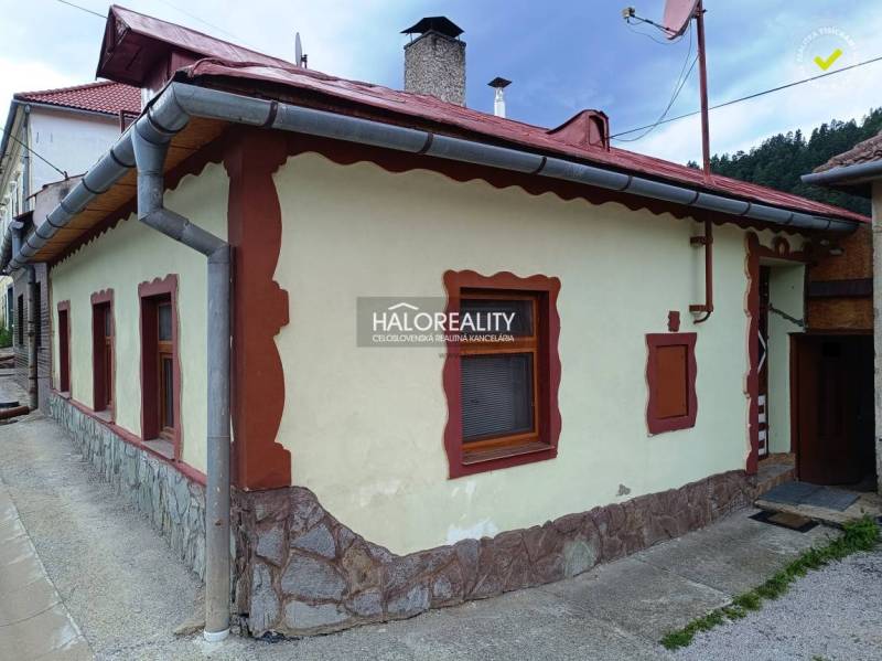 A kitchen in a family house with rustic furniture, wooden flooring, and decorations.