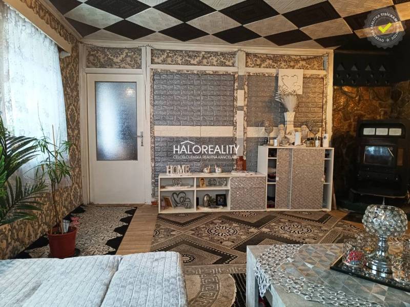 Bedroom in a family house with a bed, cabinet, and a plush teddy bear.