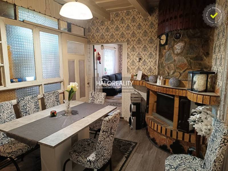 A comfortable living room in a family house with elegant wallpaper and stylish patterns.