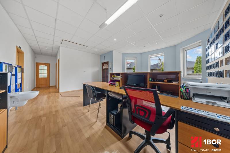 Office in a family house with a desk, computer, and wooden floor.