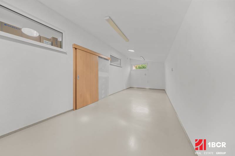 A bright room with white walls and wooden sliding doors in a family house.