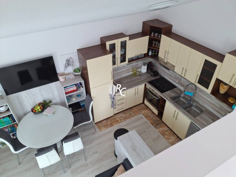 A kitchen in a 4-room apartment with a dining table and built-in wardrobes.