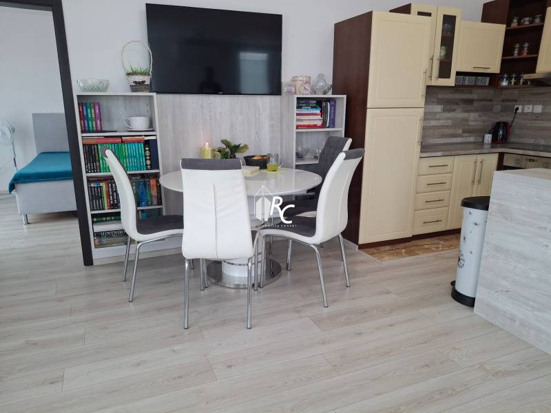Dining room with a library and kitchen in a 4-room apartment.