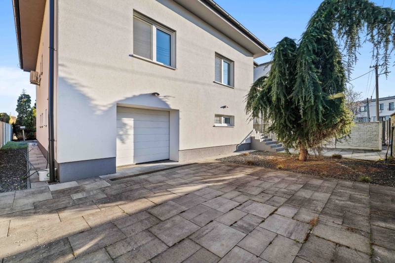 Two-story family house on Pluhová Street with a garage and a driveway.