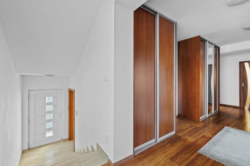 Interior of a family house with wooden floors and cabinets on Pluhová Street.