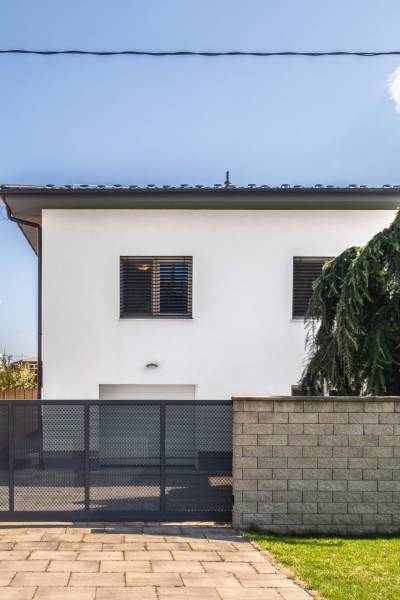 A family house on Pluhova Street in Ivanka pri Dunaji with a garden and a gate.