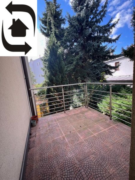 A balcony of a 5 or more room apartment with a view of greenery.
