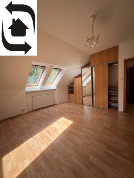 Attic room with wood-decor flooring and a built-in wardrobe, 5 or more bedroom apartment.