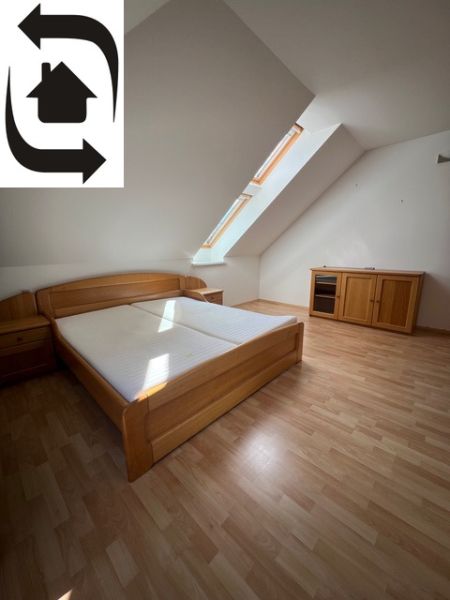 A bedroom with a wood-decor floor in a 5 or more room apartment, attic room.