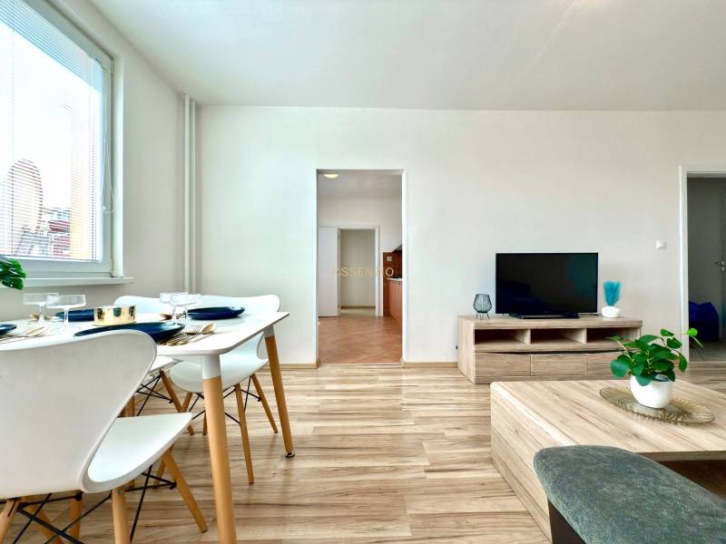 Living room in a 3-room apartment with a dining area and a television.