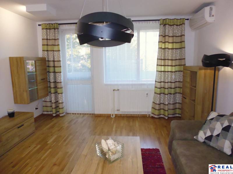 Living room of a 3-room apartment with wooden furniture, a sofa set, and decorative curtains.
