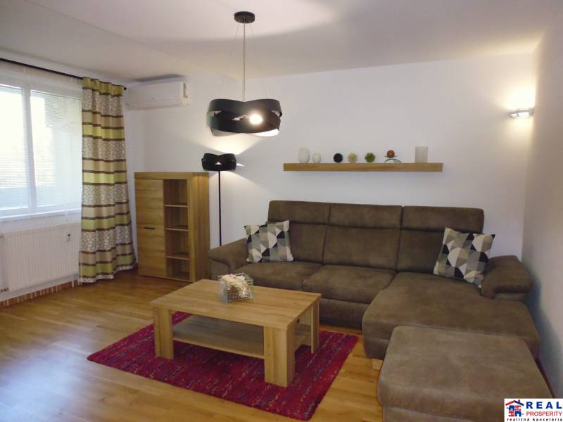 Living room in a 3-room apartment with a sofa, shelf, and floor lamp.