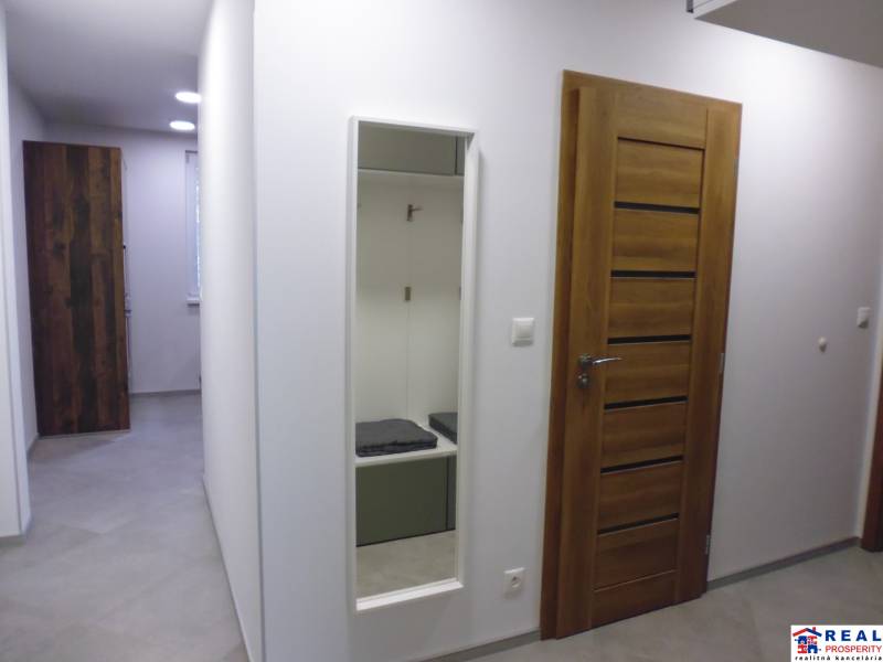 A hallway with doors and a mirror in a 3-room apartment, simple design.