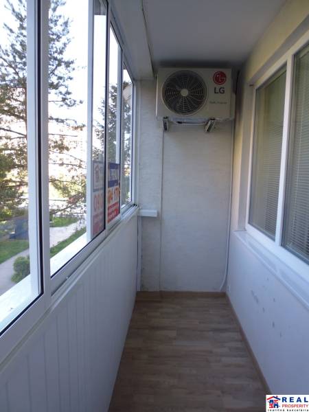 Glazed balcony with air conditioning and a view within a 3-room apartment.