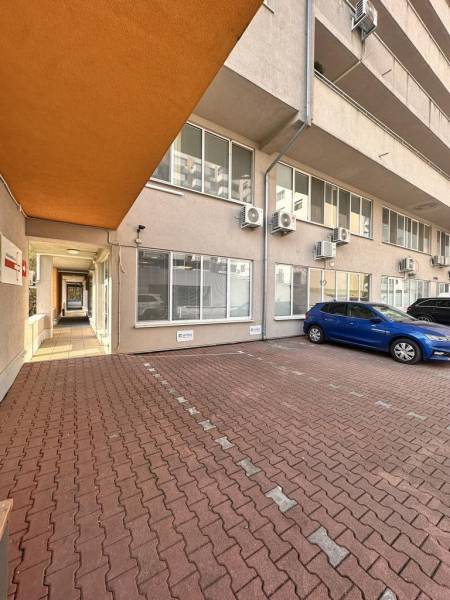 A view of office spaces on Antolska Street in Bratislava - Petrzalka with a parking lot.